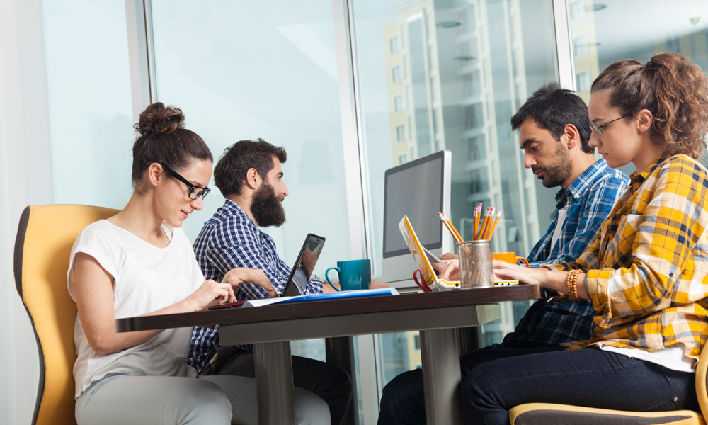 Team members participating in a structured break session in modern office environment