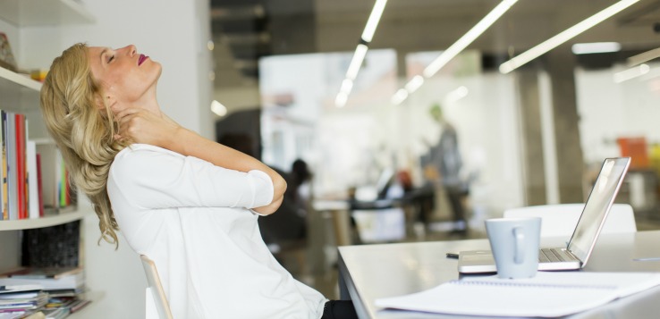 Professional practicing a silent desk stretch in a quiet office environment